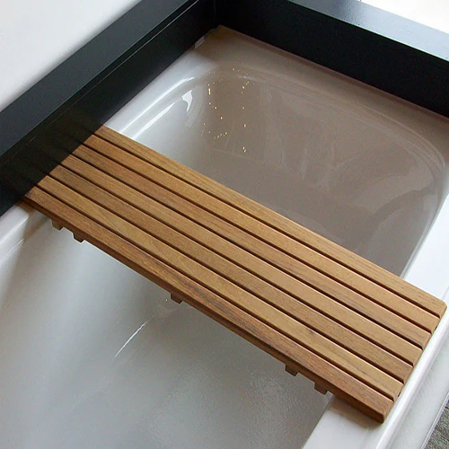 What feature is included on the underside of the tub bench in the Teak Bathtub Shelf/Seat?